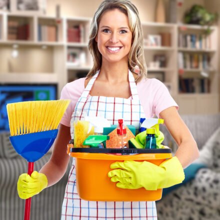 Young smiling cleaner woman in modern house